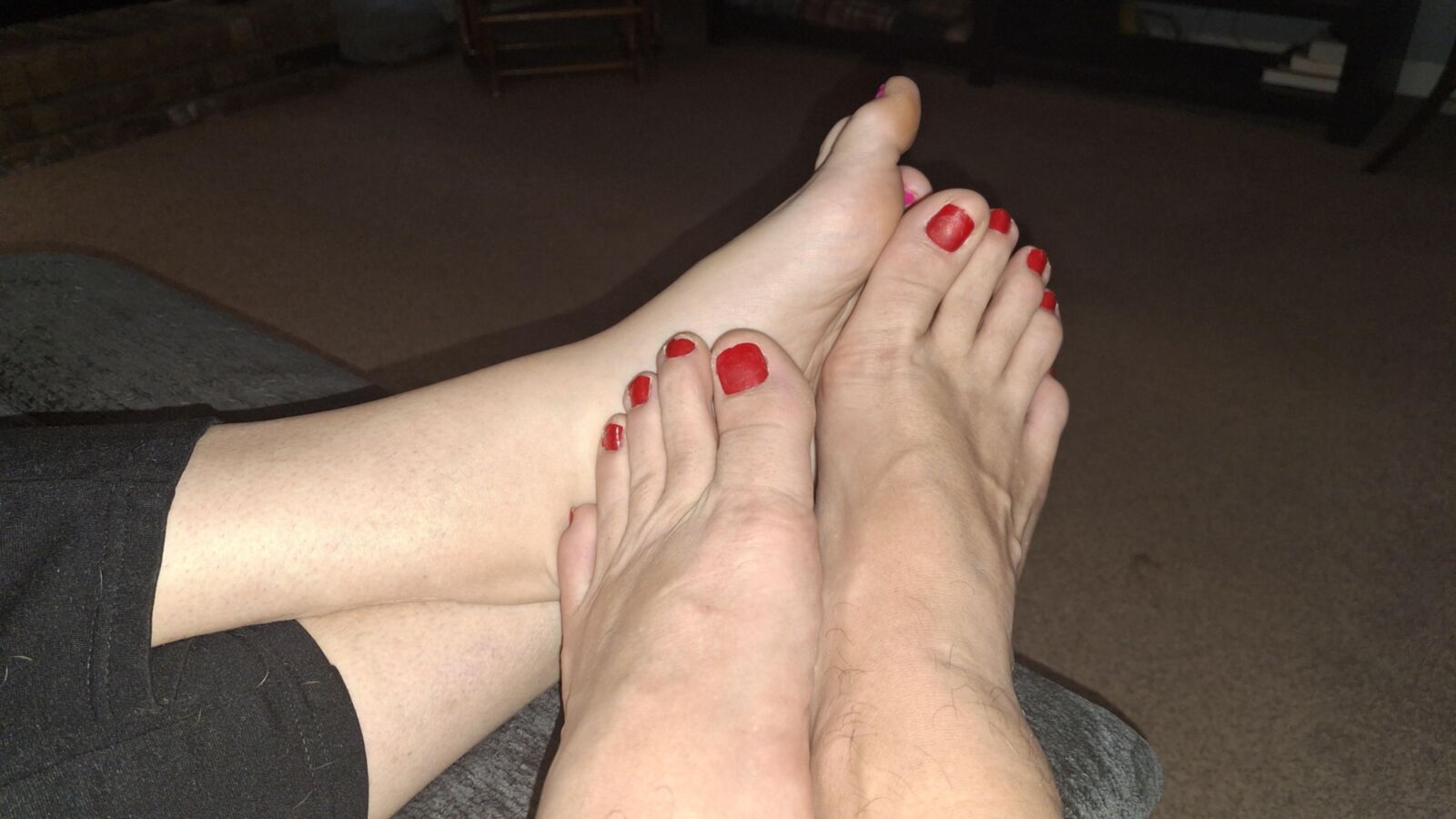 Red toe footsie showing off our feet and toes