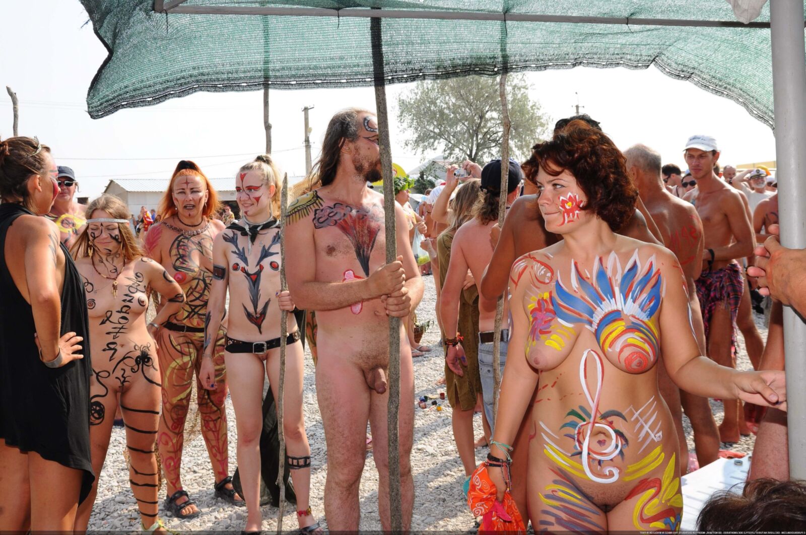 Nudist club body painting at the beach